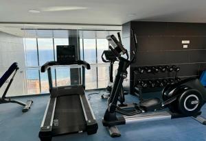 a room with a gym with a treadmill and a laptop at Benidorm Beach - By Apturist in Benidorm
