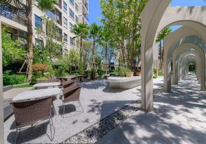 a courtyard with tables and chairs in a building at Lacasita Luxury 427 Near Huahin Beach in Hua Hin