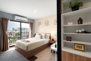 a bedroom with a bed and a balcony at Lacasita Luxury 427 Near Huahin Beach in Hua Hin +15 photos