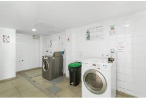 a laundry room with a washing machine and a washer at La Lajilla Arguineguin in Arguineguín