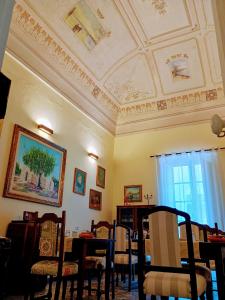 a dining room with a coffered ceiling and tables and chairs at B&B Dei Bottai in Gallipoli
