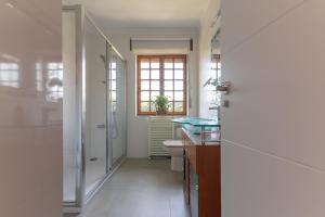 a bathroom with a shower and a toilet and a sink at Villa Glicinia in Viveda +24 photos