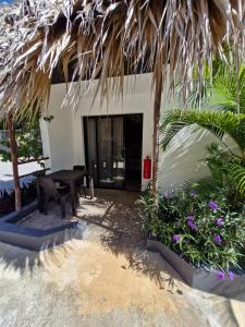 a table and bench in front of a house at BUNGALOWS COLIBRI in Las Galeras +79 photos