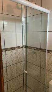 a glass shower in a bathroom with a toilet at Pousada Sabiá in Cuiabá +24 photos