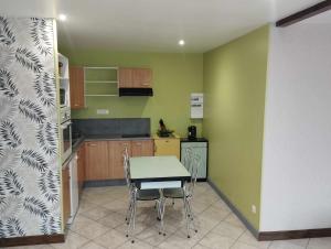 a kitchen with a table and chairs in a room at Appartement Passementier centre du bourg in La Séauve-sur-Semène