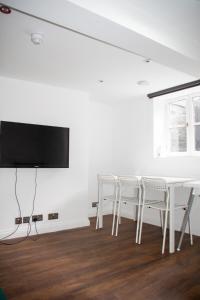 a white dining room with a white table and chairs at 6 BR 4 Bath Central Worcester Sleeps 12 in Worcester