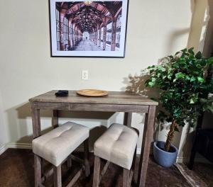 a wooden table with two chairs and a picture on the wall at Fredericksburg Stay W Patio, Fire Pit & Hot Tub in Fredericksburg +30 photos