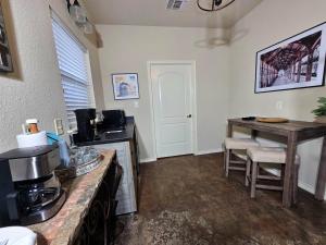a kitchen with a counter top and a table at Fredericksburg Stay W Patio, Fire Pit & Hot Tub in Fredericksburg +16 photos