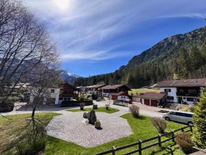 a park in a village with mountains in the background at Ferienwohnung Sonnenglück in Schönau am Königssee