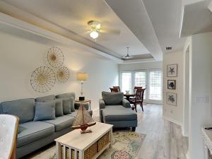 a living room with a couch and a table at Palm Coast Hideaway in Palm Coast
