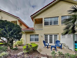 two blue chairs in front of a house at Palm Coast Hideaway in Palm Coast