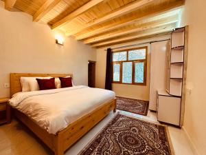 a bedroom with a large bed with a window at North Vibe Resort Hunza in Hunza Valley +14 photos
