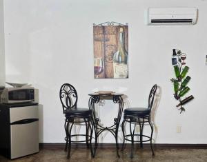 a table and four chairs in a kitchen with a picture on the wall at New Pool, Patio, Pickleball, Cornhole, Hot Tub in Fredericksburg