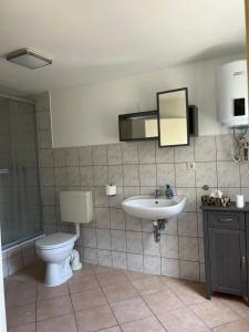 a bathroom with a toilet and a sink at Yellow Home in Lychen