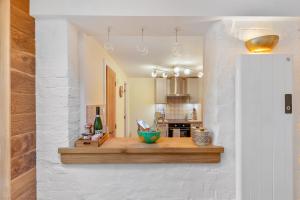 a kitchen with a counter in the middle of a room at Low Tide Bedford Rd Boutiques in St Ives