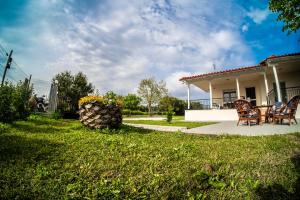 a yard with chairs and a house at Blackeye Hidden cottage in Nea Potidaea