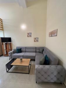a living room with a couch and a coffee table at Saranda View Apartments in Sarandë