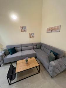 a living room with a couch and a coffee table at Saranda View Apartments in Sarandë
