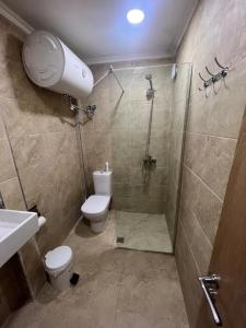 a bathroom with a shower and a toilet and a sink at Saranda View Apartments in Sarandë