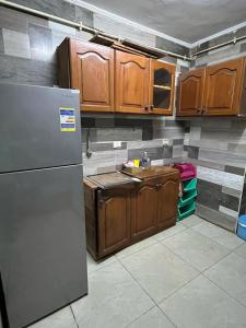 a kitchen with a refrigerator and wooden cabinets at جبال الاردن in Amman +9 photos