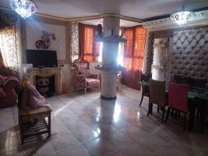 a living room with a fireplace and a table and chairs at جبال الاردن in Amman
