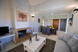 a living room with a couch and a fireplace at Regalo Apartments in Lygia