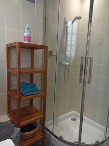 a shower in a bathroom with a glass shower stall at Entre 2 Châteaux in Onzain