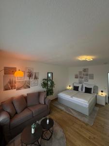 a living room with a bed and a couch at Peak11 Fewo- Panorama View Lahnstein Pool & Sauna in Lahnstein +22 photos
