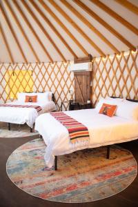 a bedroom with two beds in a yurt at Johnny Yurts - The Pearl in Johnson City