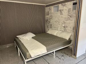 a bed with two pillows on it in a room at Zum Sterngässchen in Ludwigshafen am Rhein