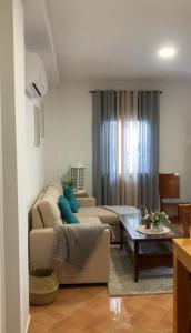 a living room with a couch and a table at Casa Abuela Cati in Sanlúcar de Guadiana