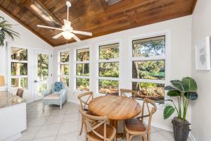 a dining room with a ceiling fan and a table at 151 Augusta National Court by Akers Ellis Rentals in Kiawah Island