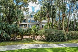 a large house with palm trees and a driveway at 161 Flyway Drive by Akers Ellis Rentals in Kiawah Island