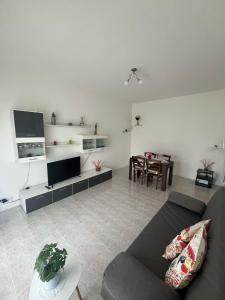 a living room with a couch and a table at Flori's Home in Bergamo