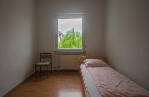 a small room with a bed and a window at Ferienwohnung Glaser in Pforzheim