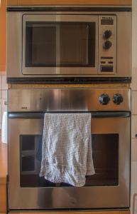a microwave sitting on top of an oven at Ferienwohnung Glaser in Pforzheim