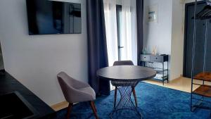 a room with a table and two chairs and a window at attico di lusso in Komotini