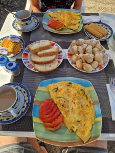 a table topped with plates of food and drinks at Rooms to let Spiropali in Piqeras