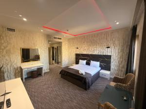 a hotel room with a bed and a television at NINE Hotel Baku 9 in Baku