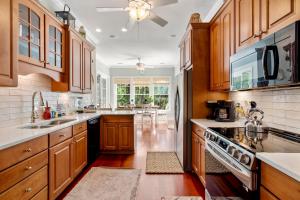 a kitchen with wooden cabinets and a stove top oven at 253 Governors Drive by Akers Ellis Rentals in Kiawah Island