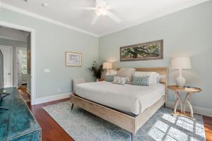 a bedroom with a bed and a ceiling fan at 253 Governors Drive by Akers Ellis Rentals in Kiawah Island +24 photos