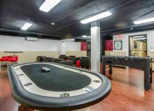 a room with a poker table and ping pong tables at Business Ready Apartment in Alexandria Modern & Central Location in Alexandria