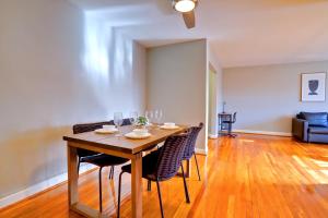 a dining room with a wooden table and chairs at Business Ready Apartment in Alexandria Modern & Central Location in Alexandria