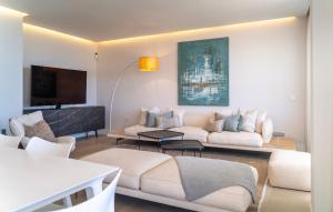 a living room with a couch and a tv at Modern 3-Bedroom Luxury Apartment with Panoramic Sea Views The Edge, Estepona in Estepona
