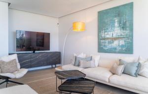 a living room with a couch and a tv at Modern 3-Bedroom Luxury Apartment with Panoramic Sea Views The Edge, Estepona in Estepona