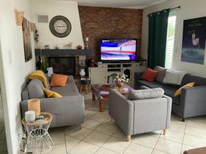 a living room with couches and a flat screen tv at Landaise 10765902 in Tarnos
