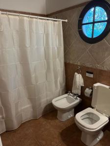 a bathroom with a toilet and a window at Posada del Virrey in Pantanillo