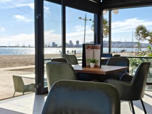 a table and chairs with a view of the beach at Klebrido Hotel and Restaurant in Durrës