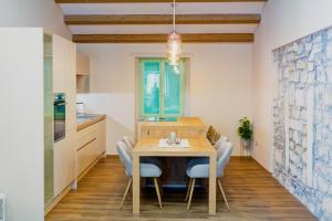 a kitchen and dining room with a table and chairs at Hiša Skala Kubed in Gračišče