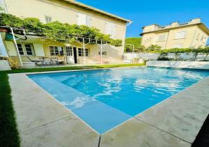 a swimming pool in front of a house at Large house & swimming pool in downtown Arles in Arles